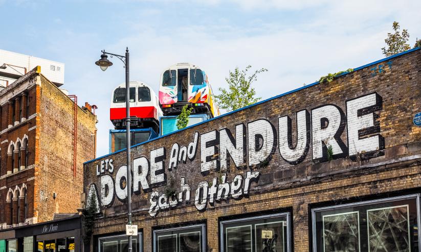 Local street art in Shoreditch, graffiti reads 'Let's adore and endure each other''